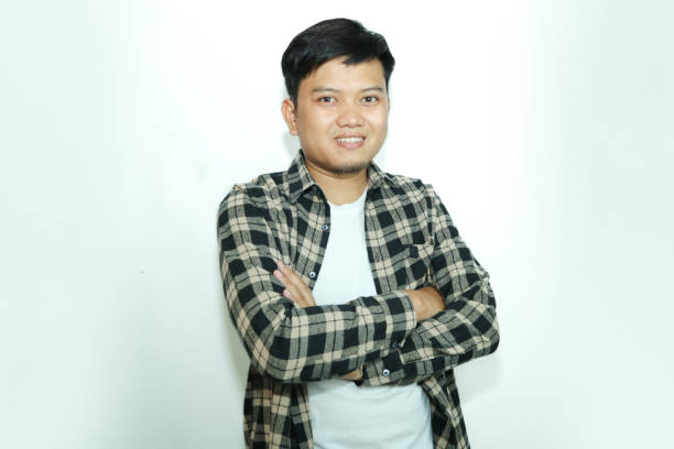istock Young Asian man standing confident with arms crossed showing happy expression 2148672254