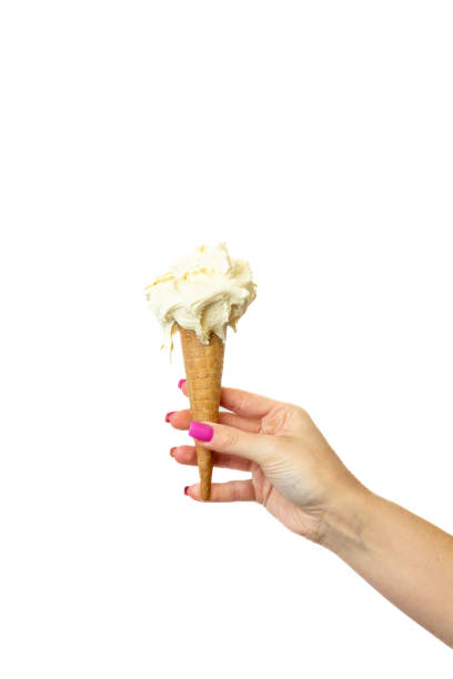 istock Eggnog Ice cream cone with female hand on white background 2148672292