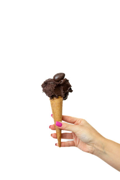 istock Dark chocolate Ice cream cone with female hand on white background 2148672316