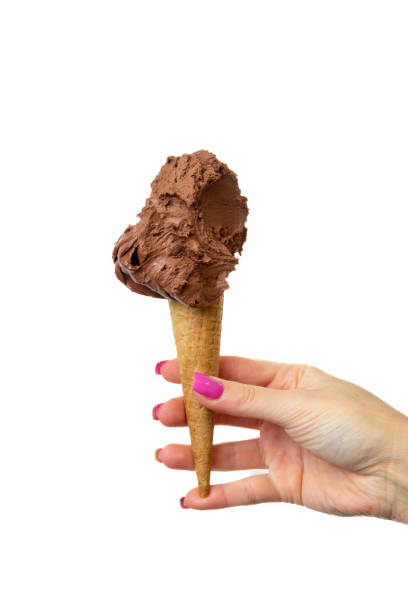 istock Vegan chocolate Ice cream cone with female hand on white background 2148672329
