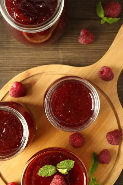 Photo of Concept of tasty food with raspberry jam on wooden background