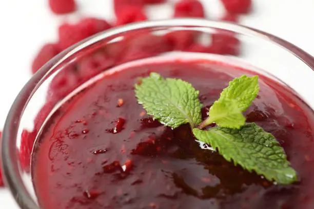 Photo of Bowl of raspberry jam, close up and selective focus