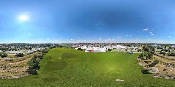 Benoni, South Africa - April 11, 2024: Panoramic view of Lakeside Mall seen from the Lakeside, with water hyacinth  covering the lake. Benoni is situated in the East Rand 26km from Johannesburg.