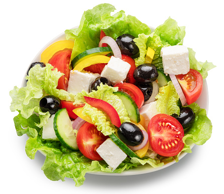 Greek salad  close up on white abcground. File contains clipping path. Flat lay or top view.