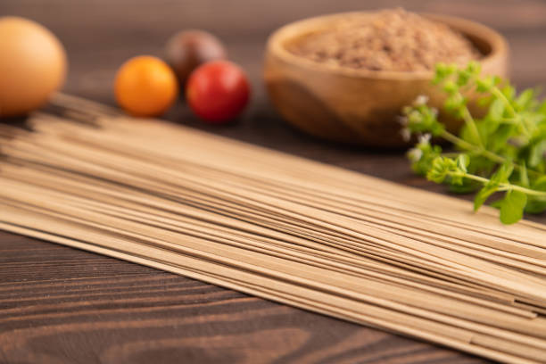 Japanese buckwheat soba noodles. Classic ingredient for preparing traditional dishes. Hard light, dark shadow, white background, top view