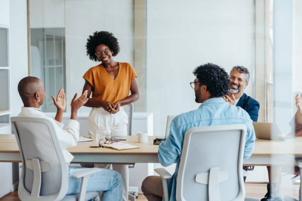istock Successful business team applauding and celebrating their project in a creative boardroom meeting 2148673881