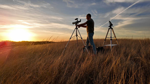 istock Amateur astronomer observing Solar eclipse and Sun with a telescope and special solar filter. 2148674030