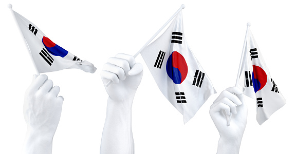 Three isolated hands waving South Korea flags, symbolizing national pride and unity