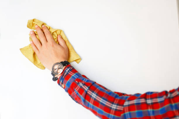 istock man's hand with a rag wipes the white board 2148675535