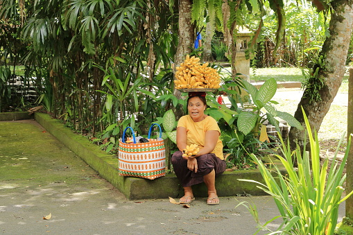 Bali in Indonesia - January 31 2024: a lady selling banana fruits