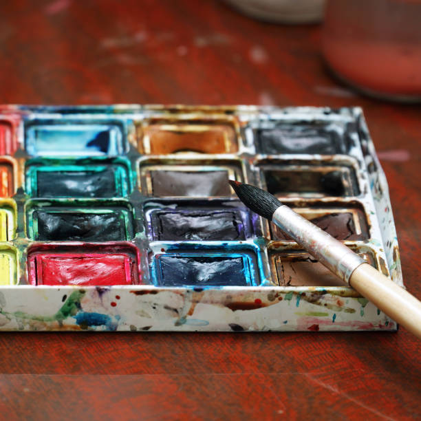 istock Watercolor paints and a brush on the table 2148678477