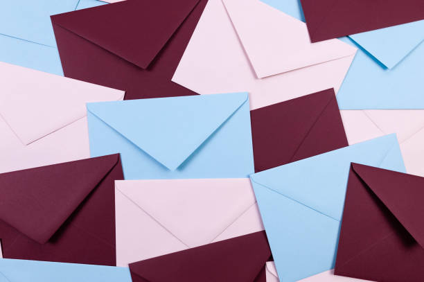 istock Top view of colourful envelopes. Pink, blue and dark red envelopes flat lay. 2148679225
