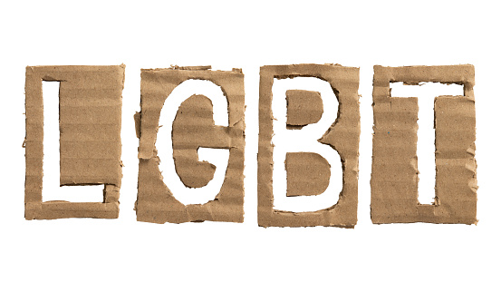 LGBT stands for lesbian, gay, bisexual, and transgender. Letters cut out from a cardboard on white background with clipping path