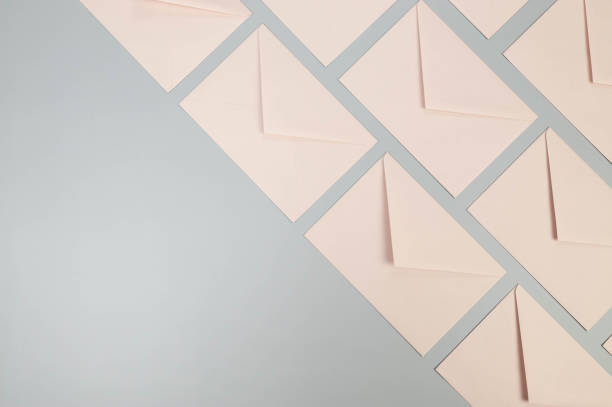 istock Top view of pink envelopes on grey background. 2148679569