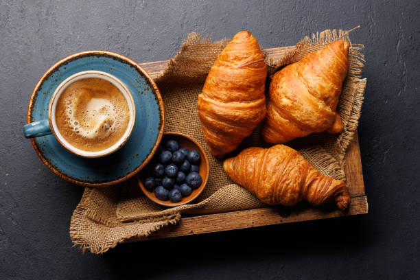 istock Cappuccino coffee and fresh croissants 2148679926