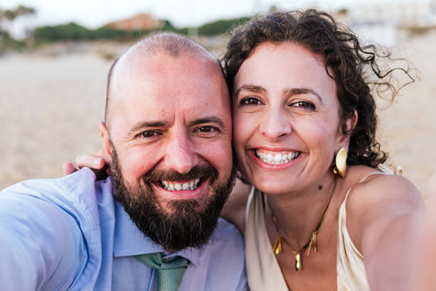 istock Couple Taking a Selfie at Beach Sunset 2148680039