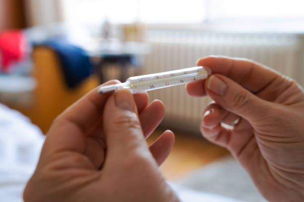 istock Sick woman checking the temperature at home. 2148680323