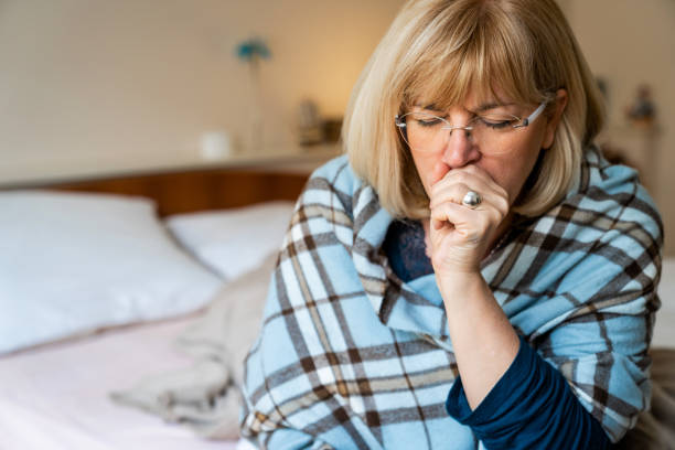 istock Senior woman coughing after wake up on bed 2148681386