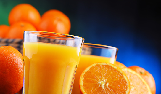 Glasses with freshly squeezed orange juice and fruits