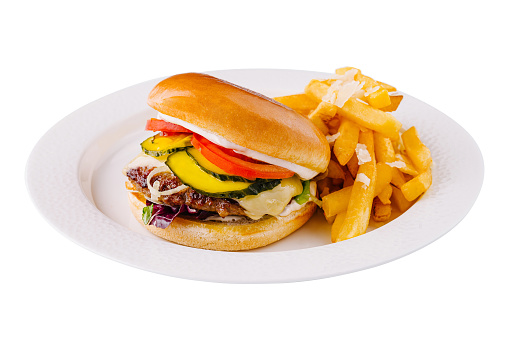 Juicy beef cheeseburger with fresh toppings and a side of crispy fries, served on a white plate