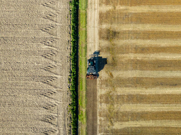 istock Tractor cultivating the soil during springtime seen from above 2148682985
