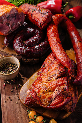 Variety of delicious smoked meats showcased on a rustic wooden cutting board