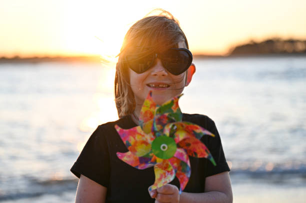 Boy holding a kite at the beach