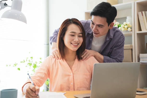 istock Two Asian businesspeople at office 2148683345