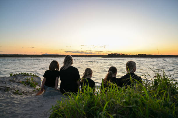 istock Lesbian couple with kids watching the sunset. 2148683594