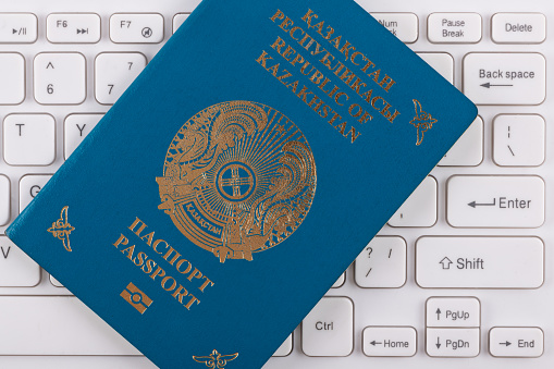 Passport of the Republic of Kazakhstan on a computer keyboard