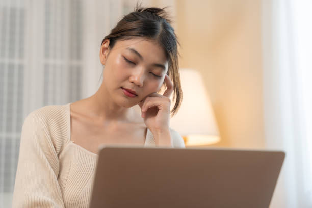 istock Pensive Asian Woman Working on Laptop. 2148684663