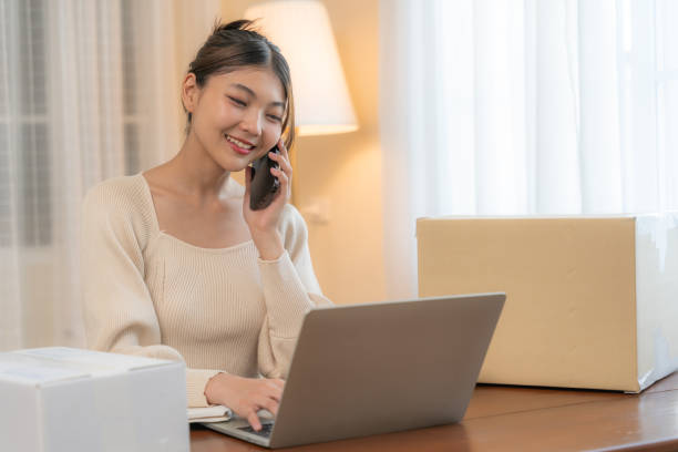istock Young Woman Working Remotely with Laptop and Phone. 2148684676