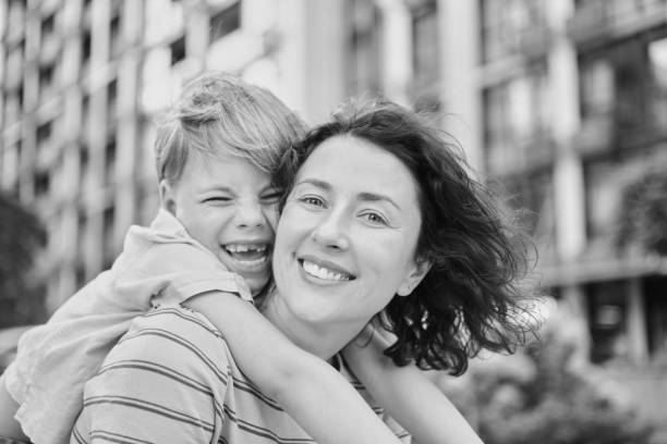 istock Young mother and son smiling looking at camera in modern residential complex 2148684894