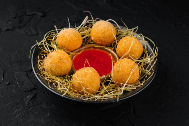 istock Crispy cheese balls with dip on hay nest 2148685316