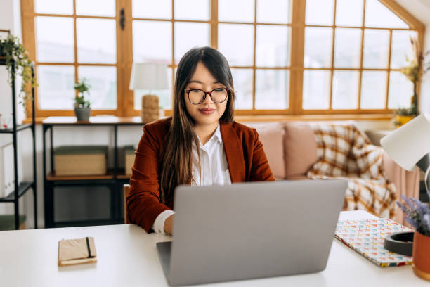 istock Young beautiful well dressed businesswoman using laptop at home office 2148685992
