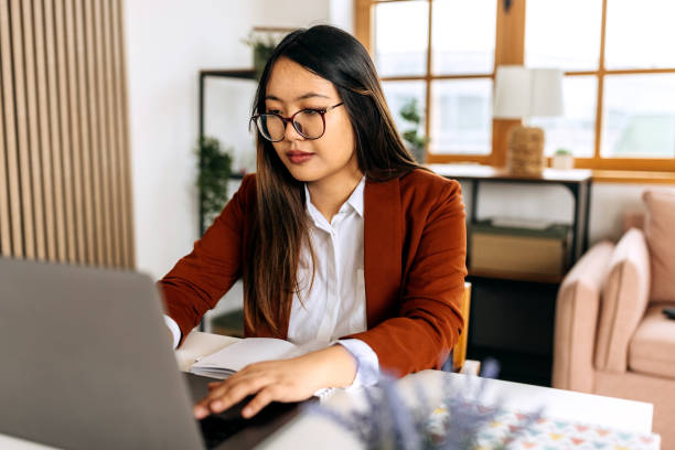 istock Young beautiful well dressed businesswoman using laptop at home office 2148686001