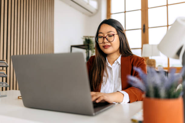 istock Young beautiful well dressed businesswoman using laptop at home office 2148686007