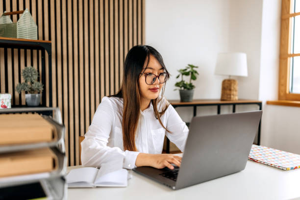 istock Young woman working on laptop at home office 2148686056