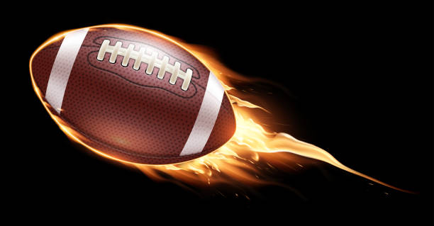 istock American football ball fire on a black background. Realistic illustration. 2148686634