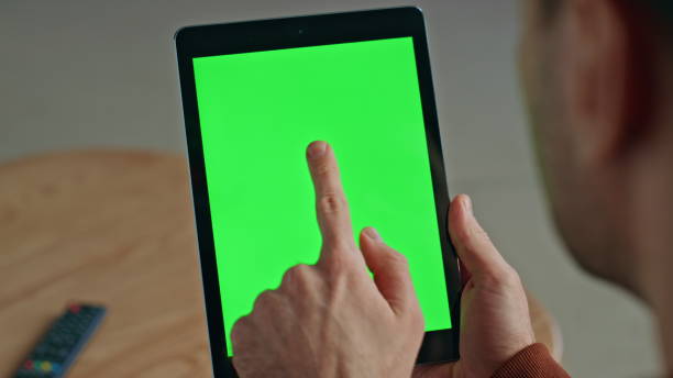 istock Guy finger touching greenscreen tablet at office room. Man using chroma key tab 2148686730