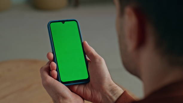 istock Man hands holding mockup smartphone at home close up. Guy with chroma key mobile 2148686781