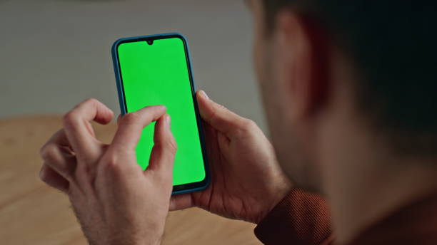 istock Manager fingers zooming chromakey cellphone indoors. Man working green screen 2148687147