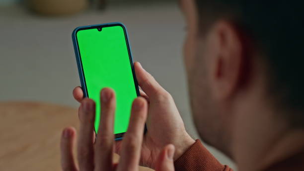 istock Gesturing guy videocalling mockup smartphone at flat closeup. Man video call 2148687296