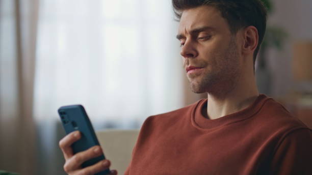 istock Pensive freelancer reading smartphone message at couch living room close up. 2148687721
