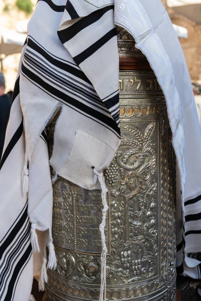 a tallit or jewish prayer shawl draped over the silver case enclosing a sefardi style torah scroll. - sephardi imagens e fotografias de stock