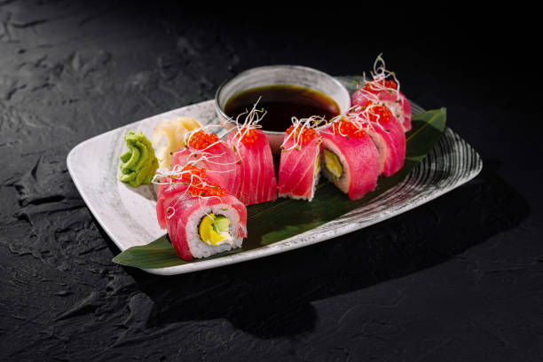 istock Exquisite tuna sushi roll on dark slate background 2148689161