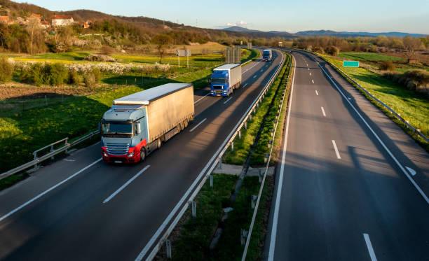 istock Transportation Trucks in lines passing 2148691346