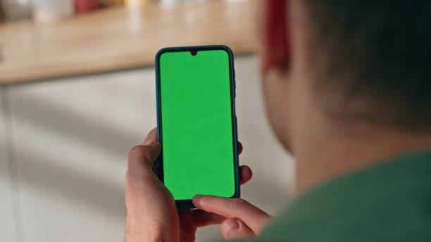 istock Guy finger touching greenscreen device indoors closeup. Man hand tapping gadget 2148691812