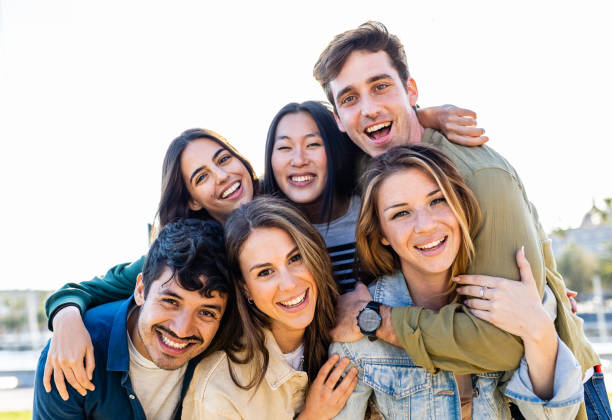 istock Diverse group of friends smile at camera outdoors 2148692013