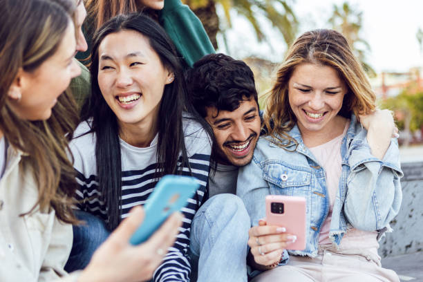 istock Generation z group of young student friends using smart mobile phone outdoors 2148692157